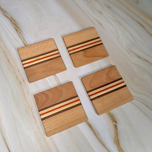 Handgjorda underlägg i björk, amerikansk valnöt och afrikanskt rosenträ, set om fyra stycken.