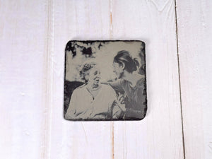 Slipat underlägg i skiffer med foto på familjen.